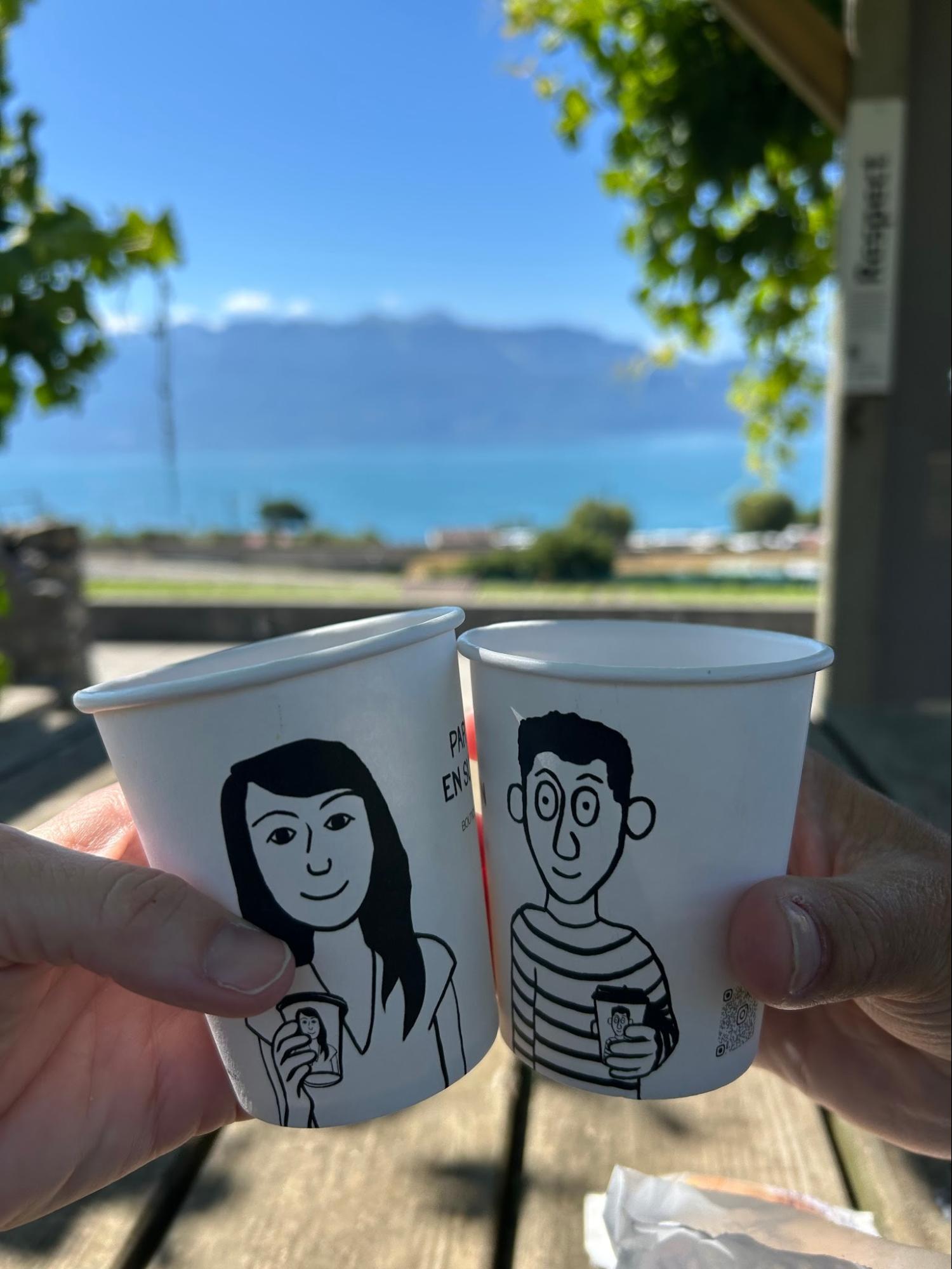 Coffee cups with Lake Geneva behind
